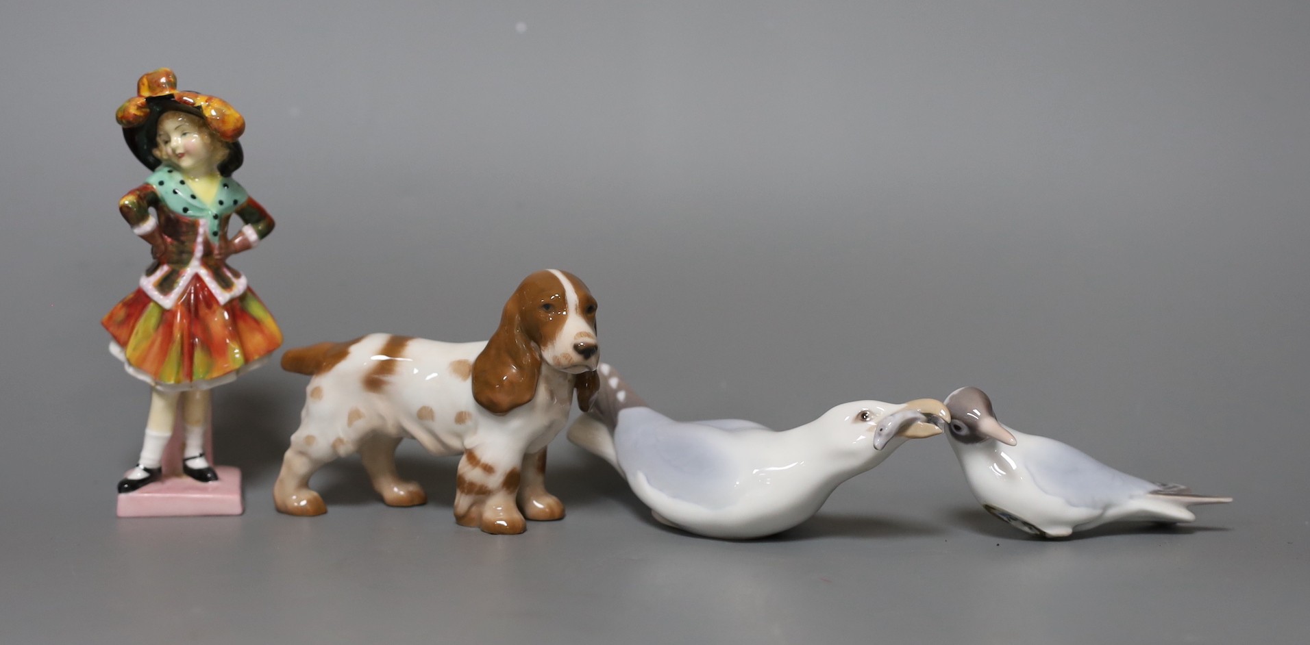 A Royal Doulton figure,”Pearly Girl”, HN 2036, two Bing and Grondahl birds and a dog, figure 14 cms high